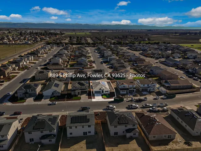 an aerial view of a building with streets and trees