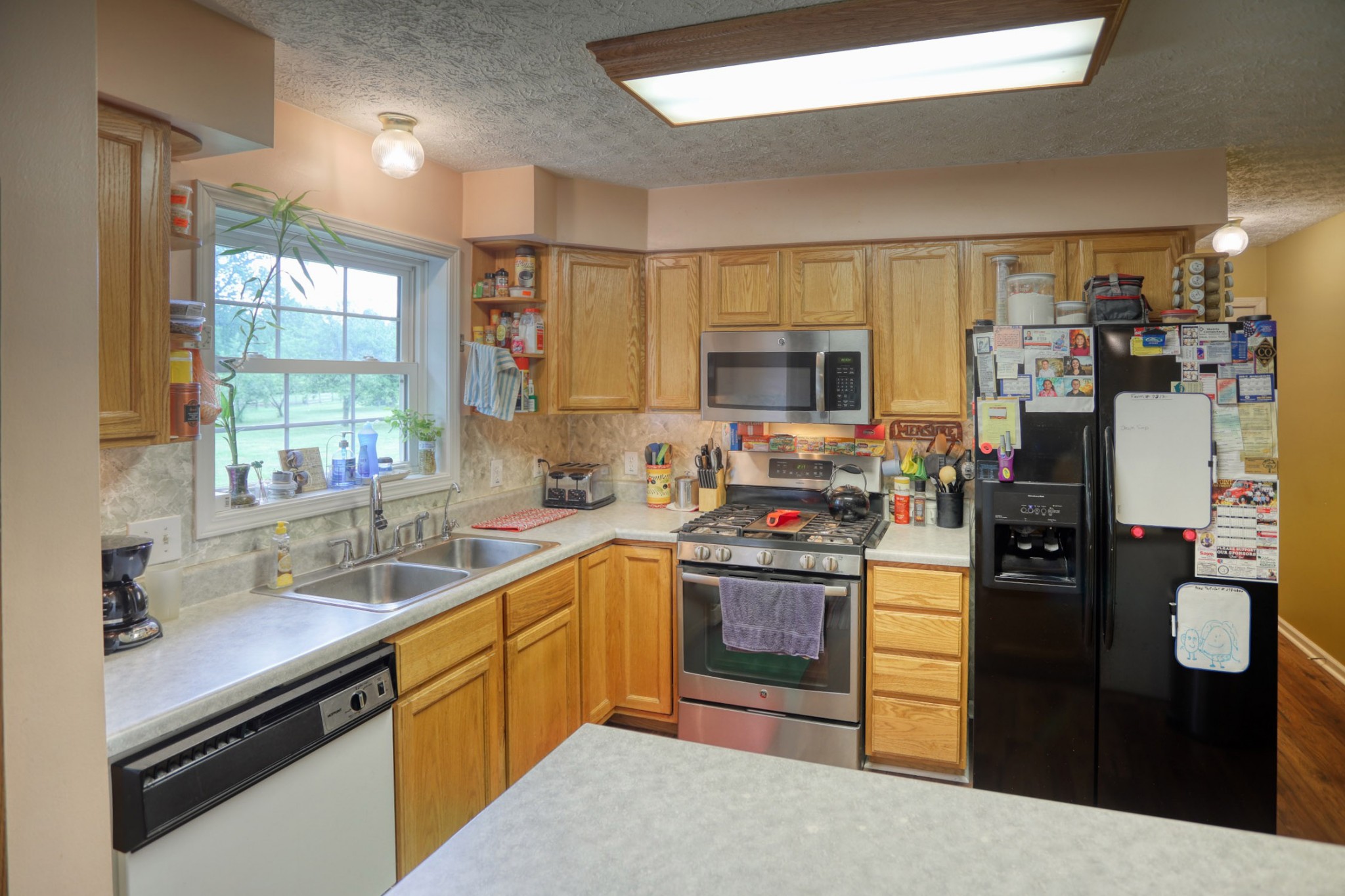 2838 New Roe Road Adolphus, KY 42120 - Photo 18 of 37 a kitchen with stainless steel appliances granite countertop a refrigerator stove and sink