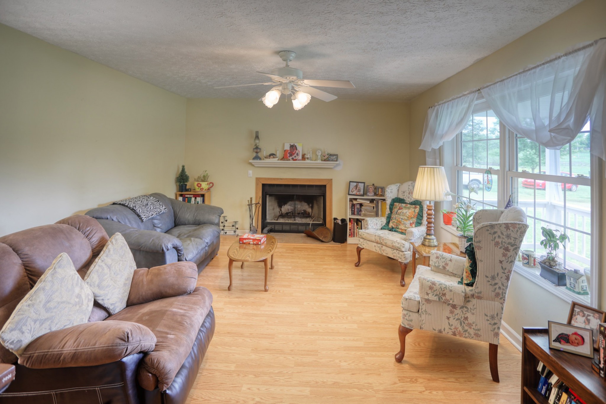 2838 New Roe Road Adolphus, KY 42120 - Photo 4 of 37 a living room with furniture a fireplace and a large mirror