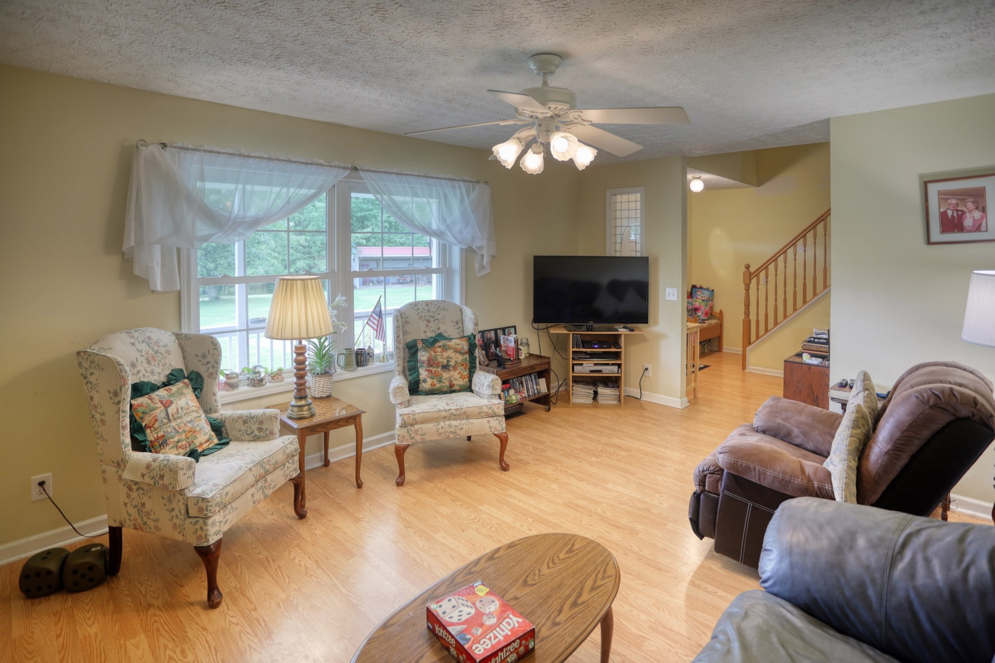 2838 New Roe Road Adolphus, KY 42120 - Photo 5 of 37 a living room with furniture a large window and a flat screen tv