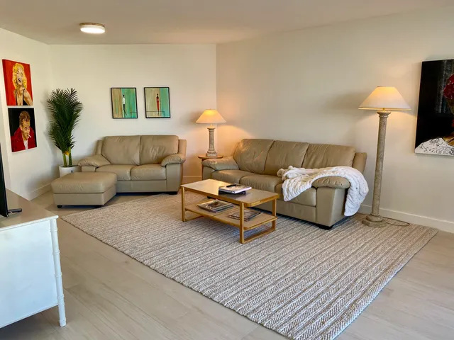 a living room with furniture and a lamp