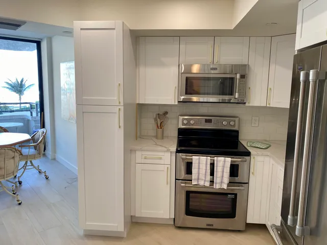 a kitchen with stainless steel appliances a stove a microwave and a refrigerator