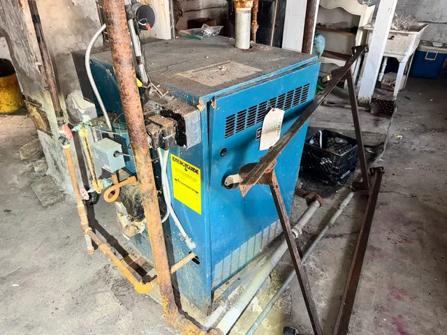 a utility room with dryer and furniture
