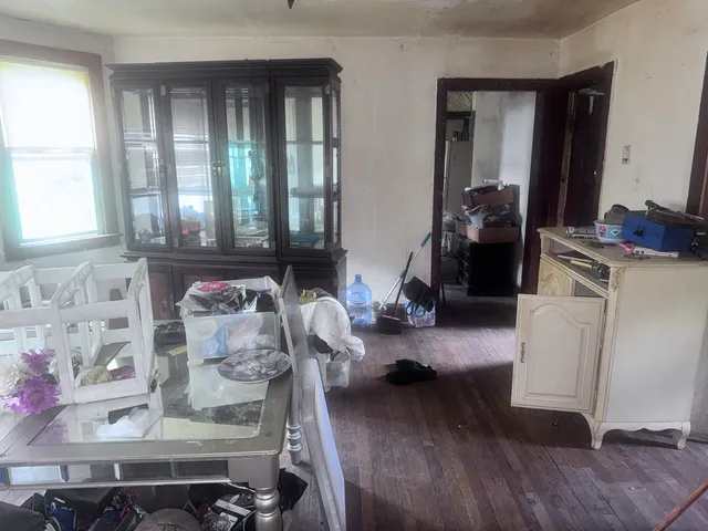 a living room with furniture and large windows