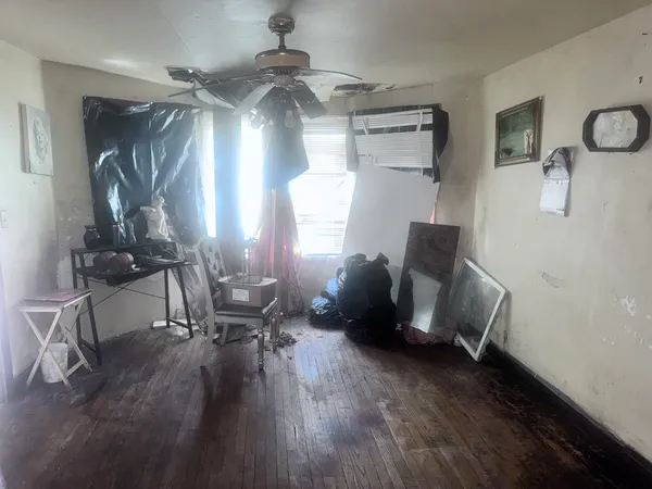 a view of a livingroom with furniture and a window