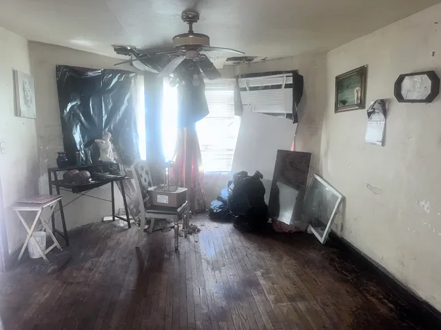 a view of a livingroom with furniture and a window