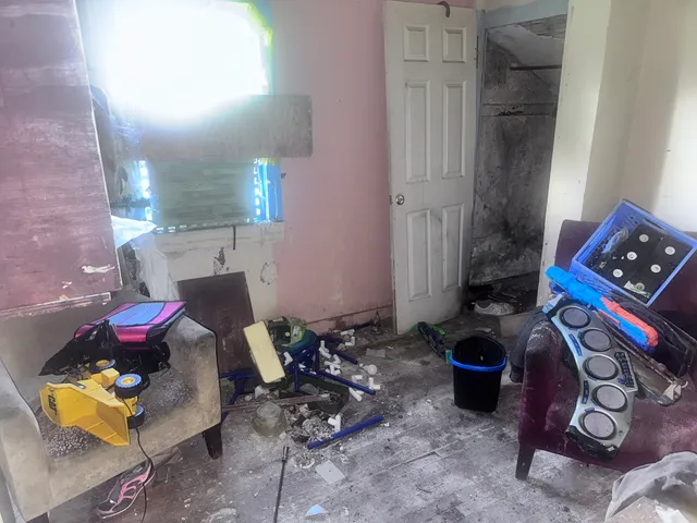 a living room with furniture and many windows