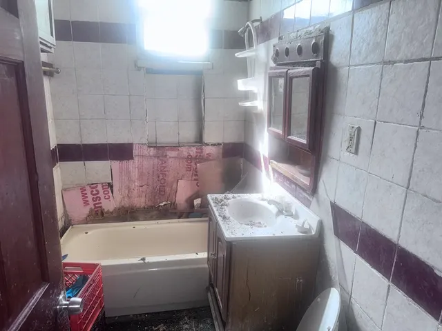 a bathroom with a bathtub and shower