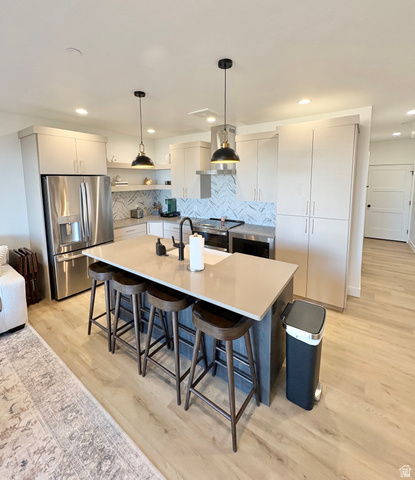 70 East Hwy 153, Unit A4 Beaver, UT 84713 - Photo 6 of 19 Kitchen featuring decorative light fixtures, stainless steel appliances, a kitchen bar, light wood finished floors, and an island with sink