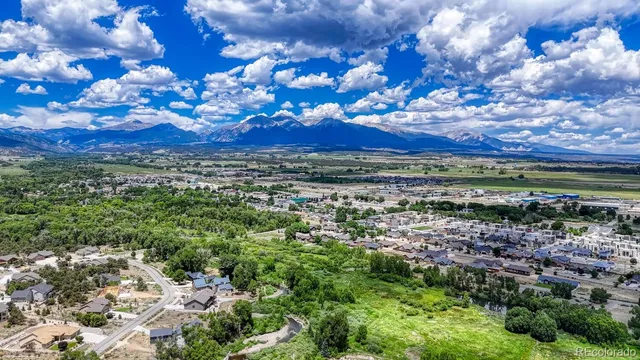a view of a yard with wooden fence