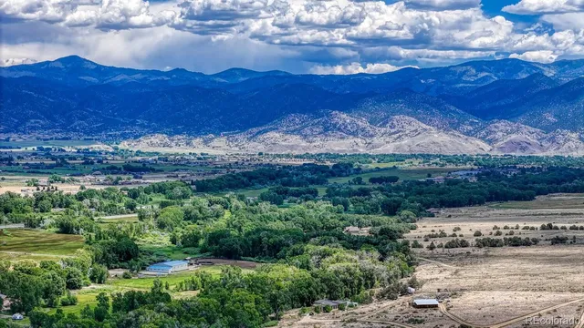 a view of mountain with sunset in background