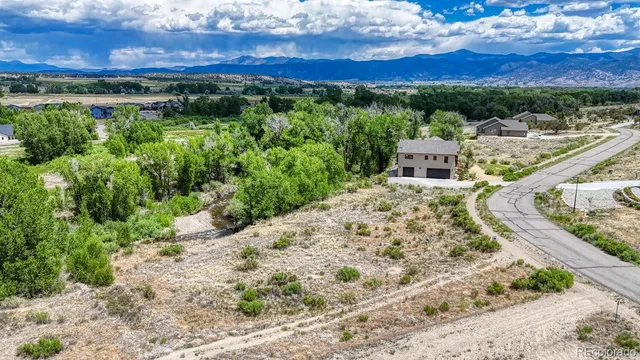 a view of a swimming pool with a yard and mountain view