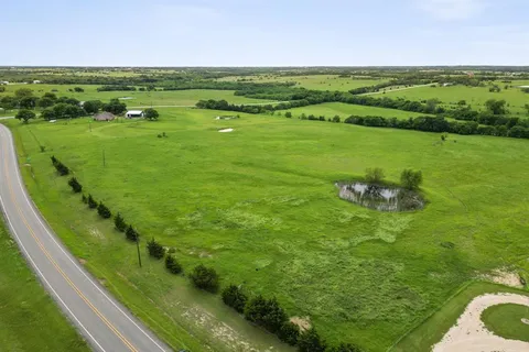 a view of a field with an ocean