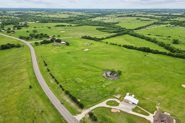 a view of a golf course with a ocean view