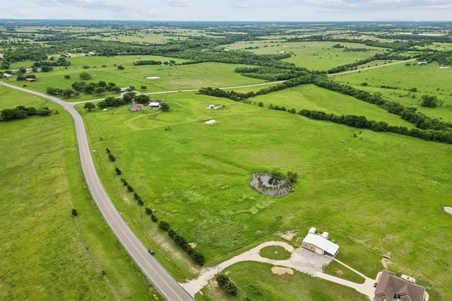 a view of a golf course with a ocean view