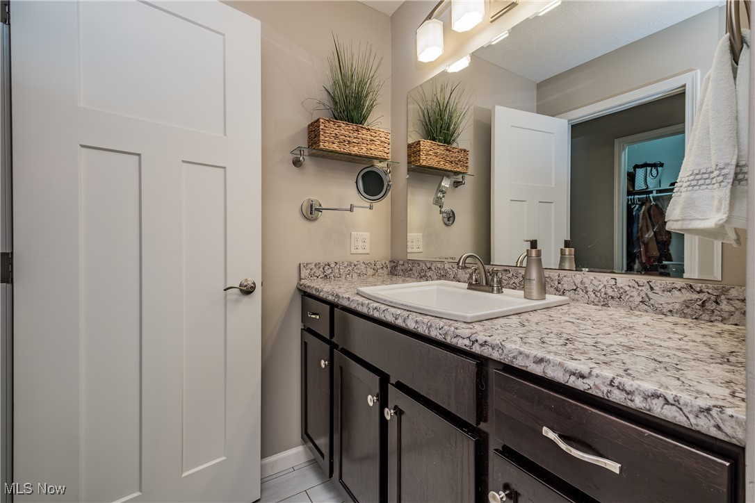 1365 Cascade Circle West Canton, OH 44708 - Photo 26 of 31 Bathroom featuring tile patterned flooring and vanity