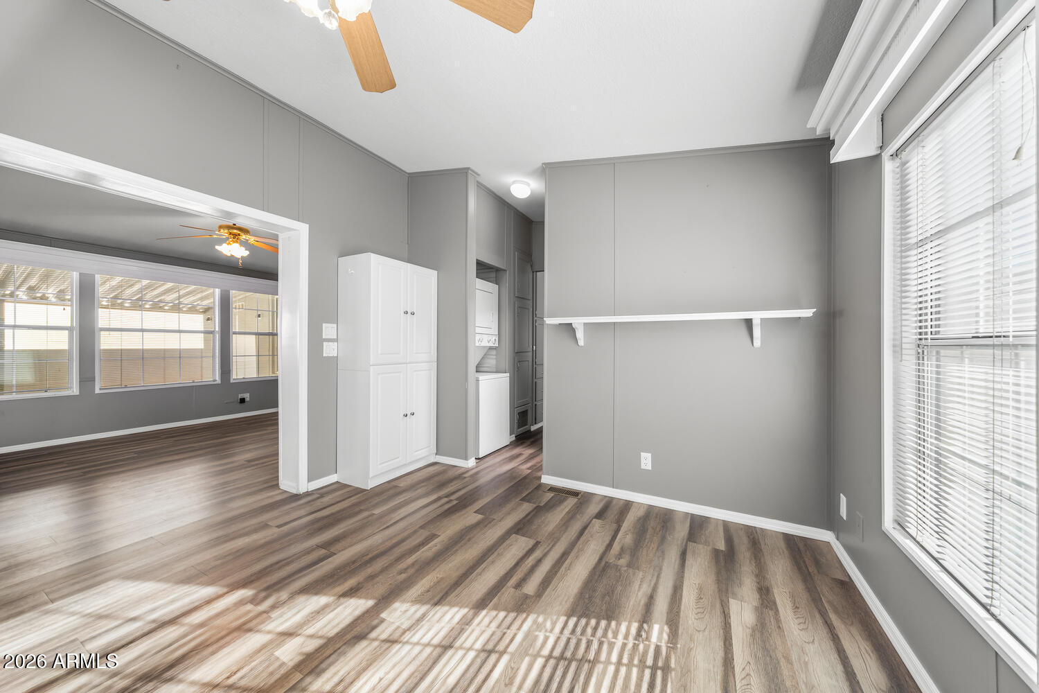 17200 West Bell Road, Unit 390 Surprise, AZ 85374 - Photo 11 of 40 a view of an empty room with wooden floor and a window