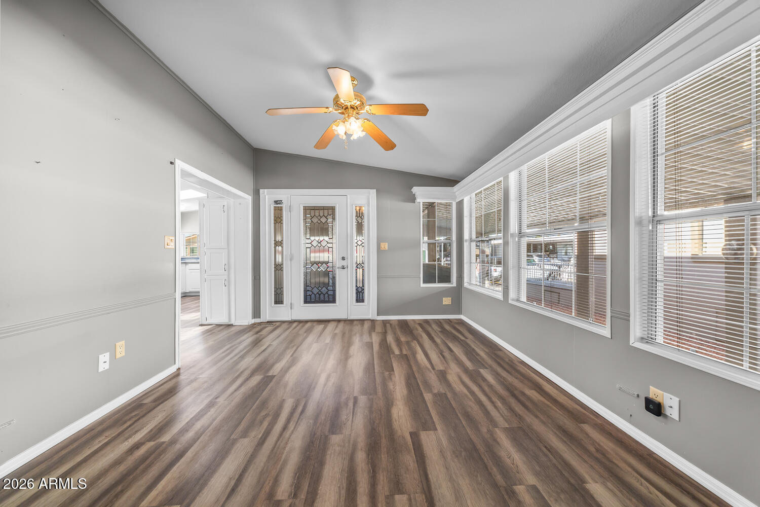 17200 West Bell Road, Unit 390 Surprise, AZ 85374 - Photo 14 of 40 a view of an empty room with wooden floor and a window