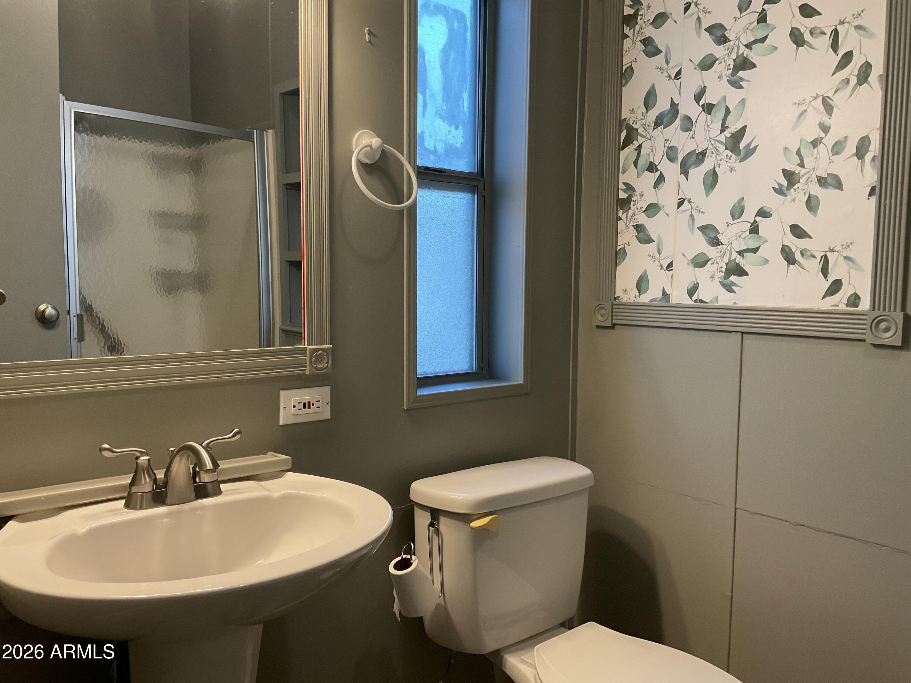 17200 West Bell Road, Unit 390 Surprise, AZ 85374 - Photo 16 of 40 a bathroom with a sink and mirror with toilet