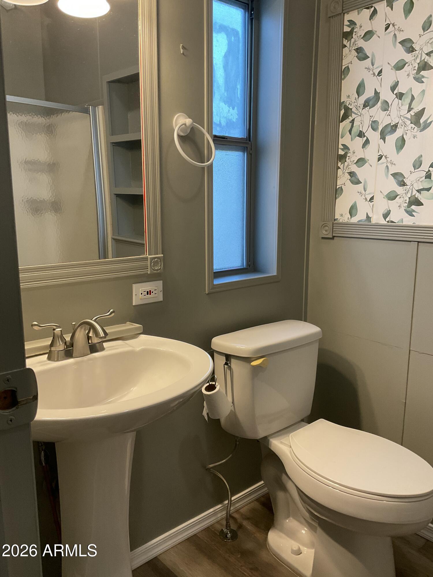 17200 West Bell Road, Unit 390 Surprise, AZ 85374 - Photo 17 of 40 a bathroom with a sink a toilet and a mirror