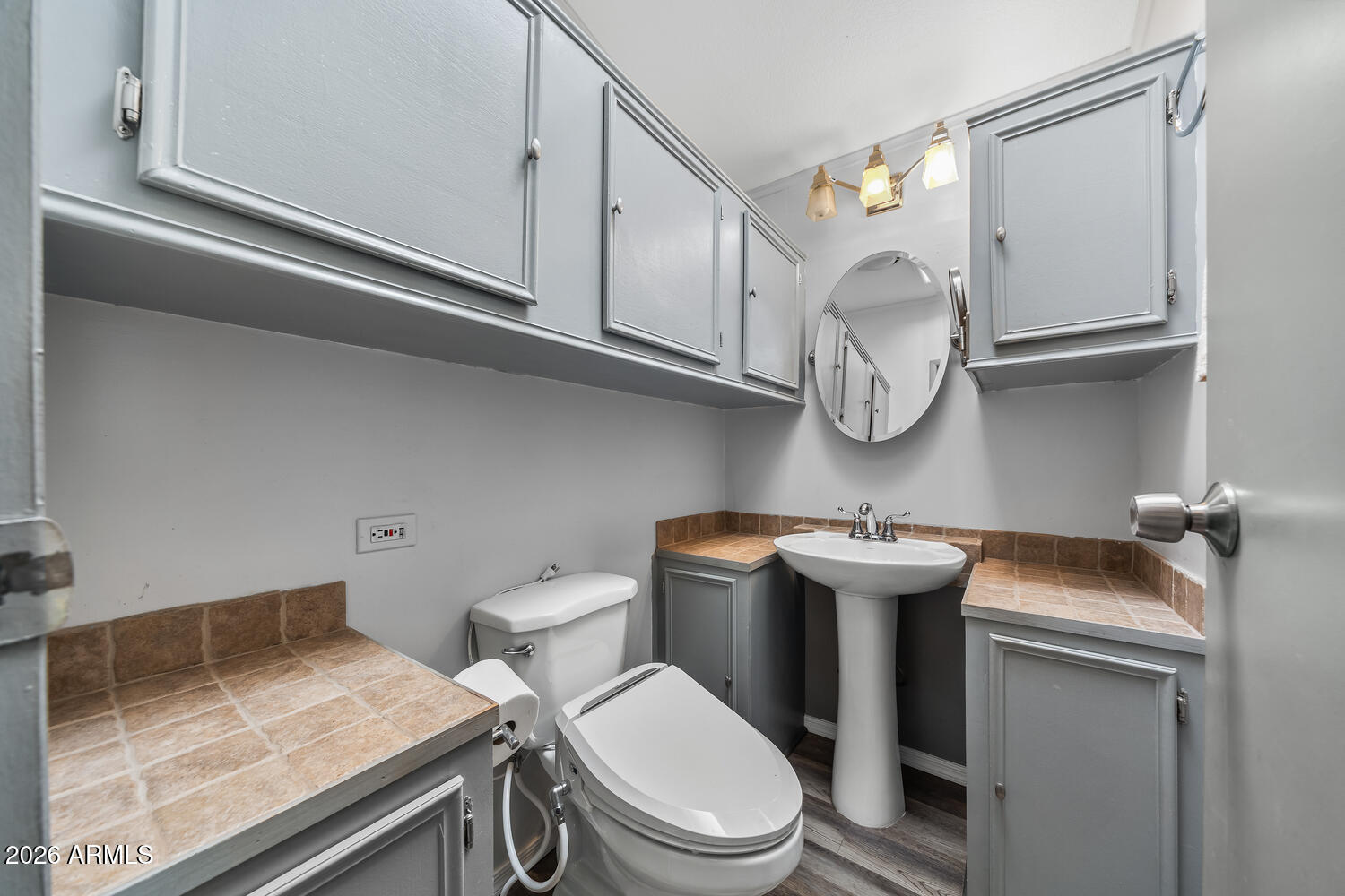 17200 West Bell Road, Unit 390 Surprise, AZ 85374 - Photo 24 of 40 a bathroom with a granite countertop toilet sink and mirror