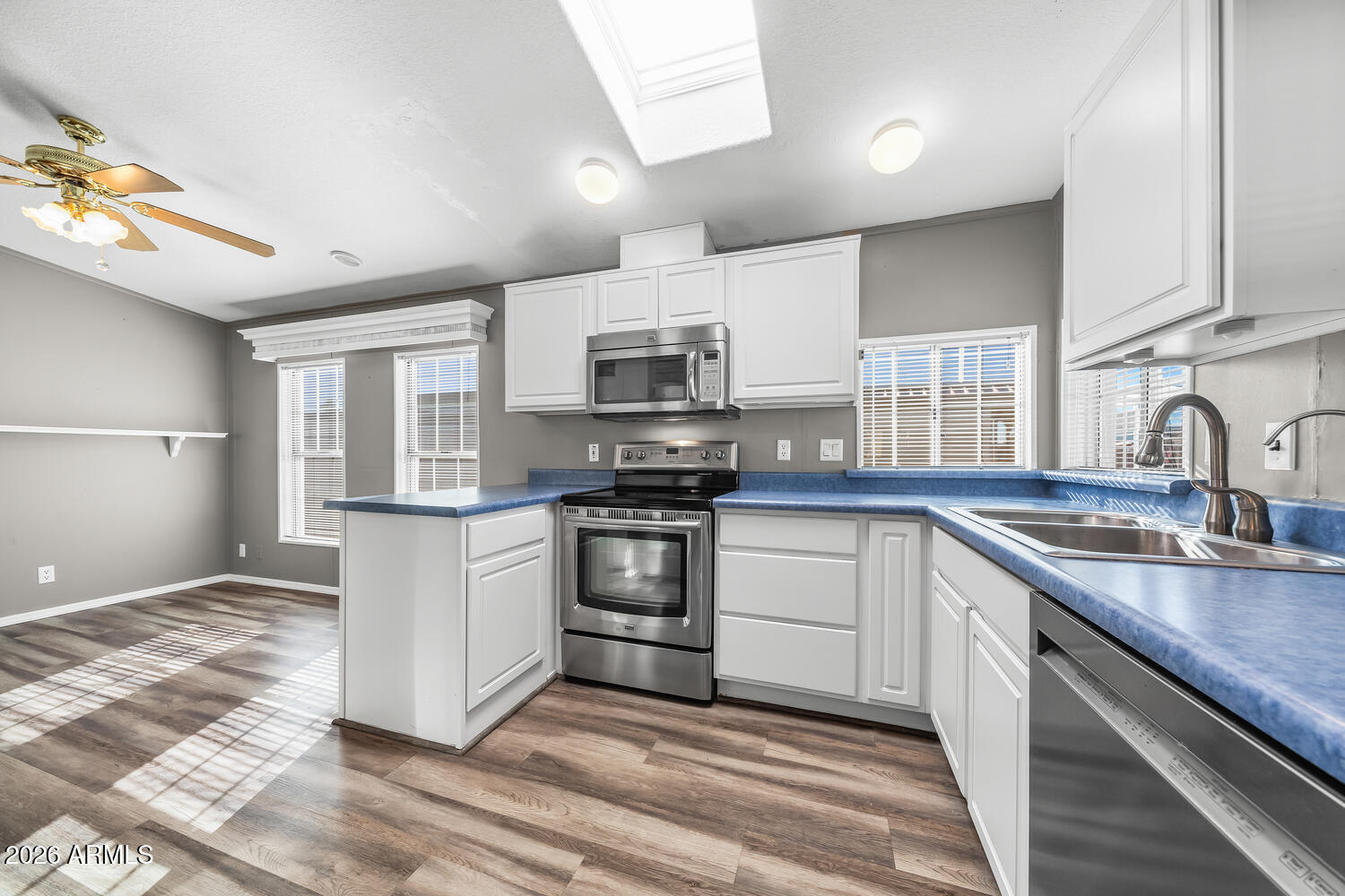 17200 West Bell Road, Unit 390 Surprise, AZ 85374 - Photo 7 of 40 a kitchen with granite countertop a sink and steel appliances