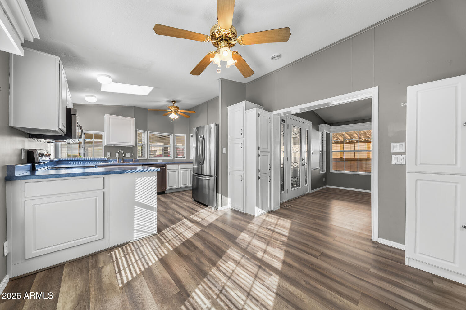17200 West Bell Road, Unit 390 Surprise, AZ 85374 - Photo 8 of 40 a kitchen with granite countertop a refrigerator and a sink