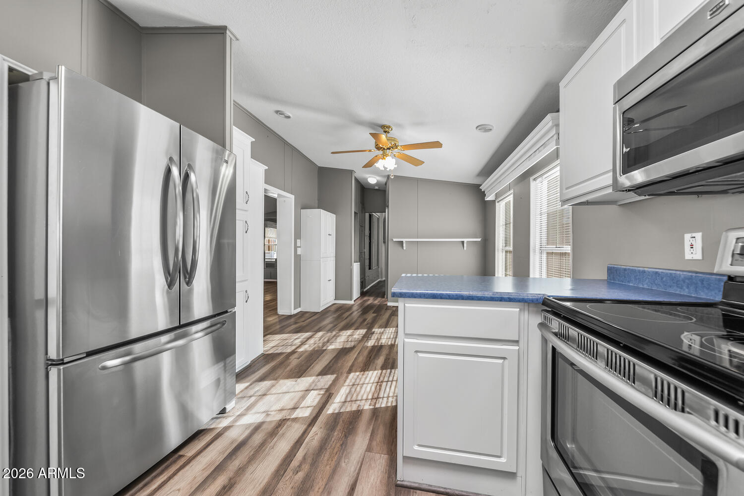17200 West Bell Road, Unit 390 Surprise, AZ 85374 - Photo 9 of 40 a kitchen with stainless steel appliances a refrigerator and a stove top oven