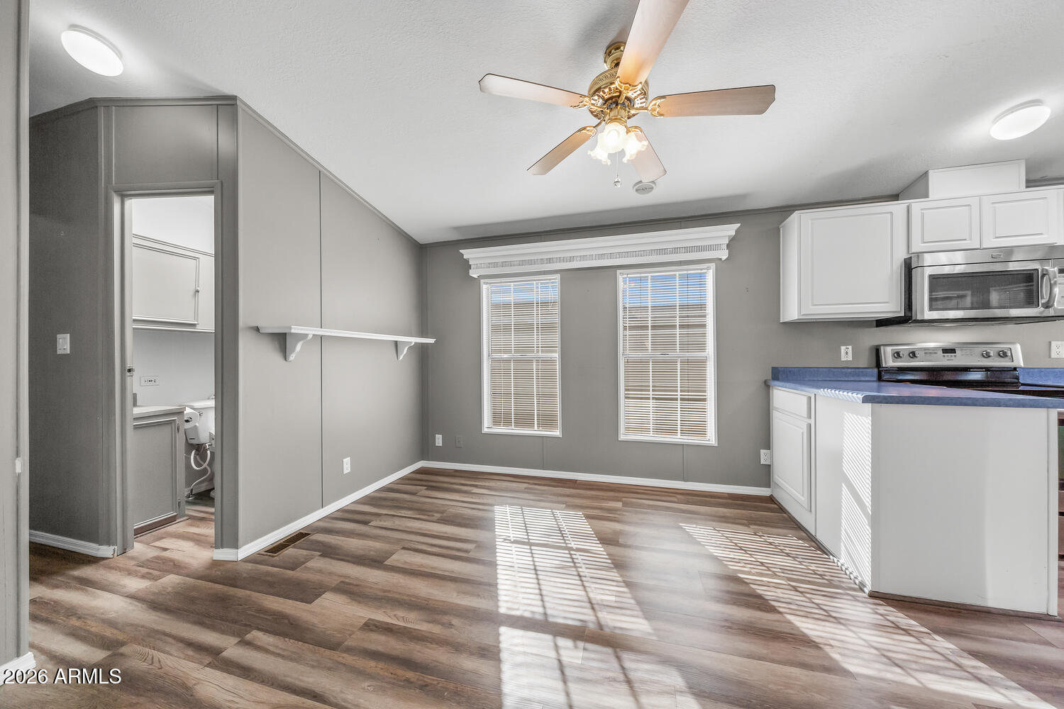 17200 West Bell Road, Unit 390 Surprise, AZ 85374 - Photo 10 of 40 a view of a kitchen with a stove cabinets and a kitchen