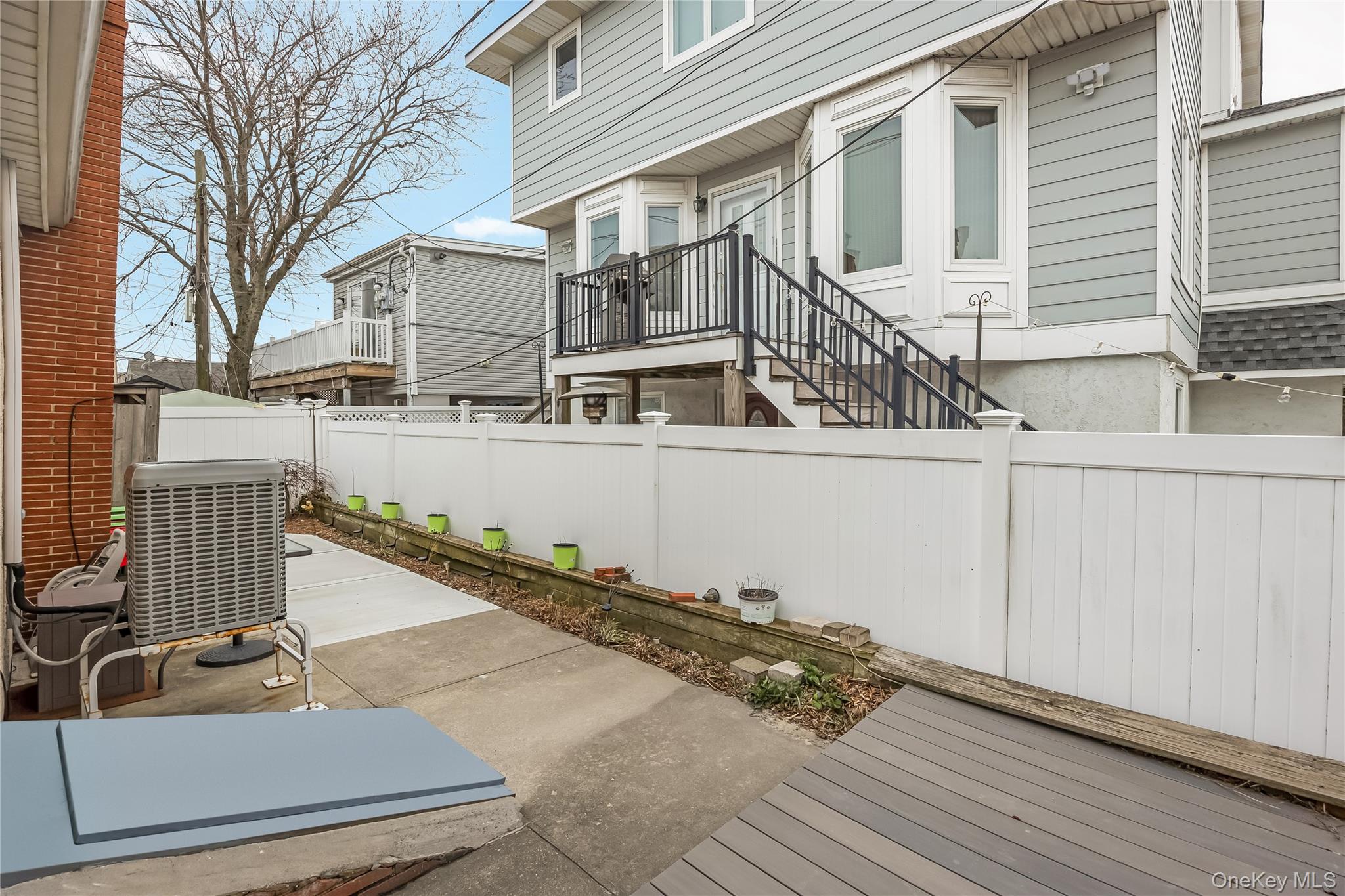 27 June Walk Long Beach, NY 11561 - Photo 17 of 20 a view of a balcony with two chairs and wooden fence