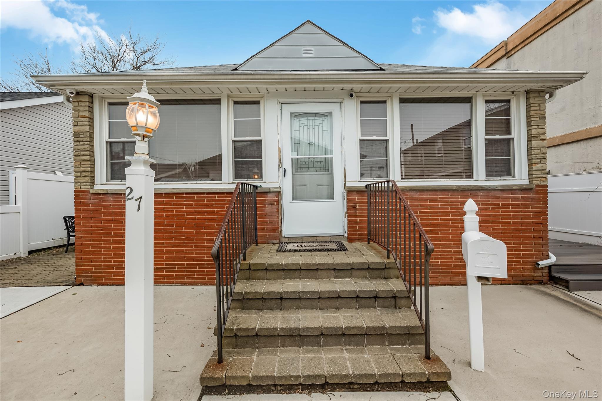 27 June Walk Long Beach, NY 11561 - Photo 4 of 20 a front view of a house with a small garden