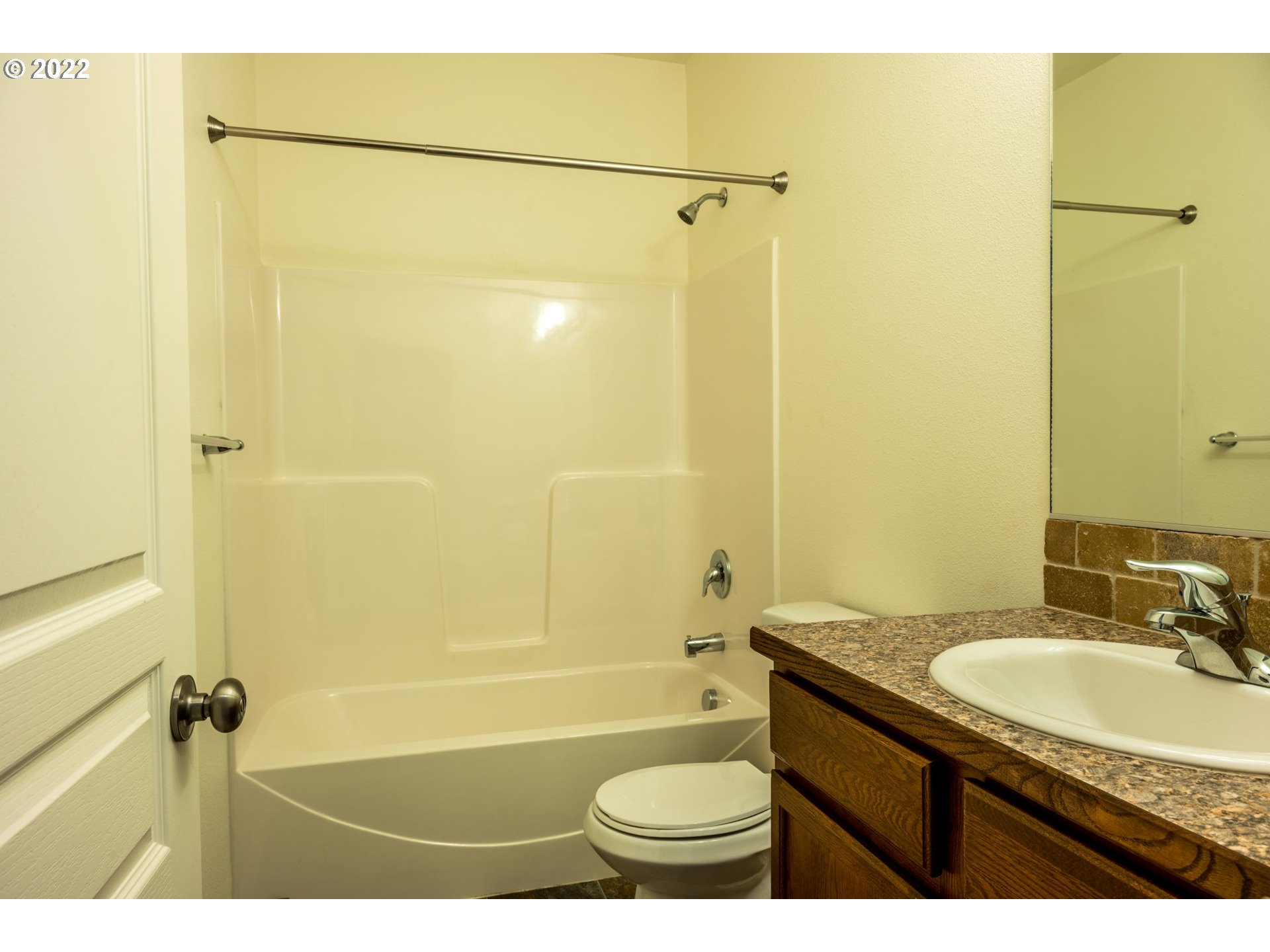 4902 Holly Street Springfield, OR 97478 - Photo 4 of 16 a bathroom with a granite countertop sink toilet and shower