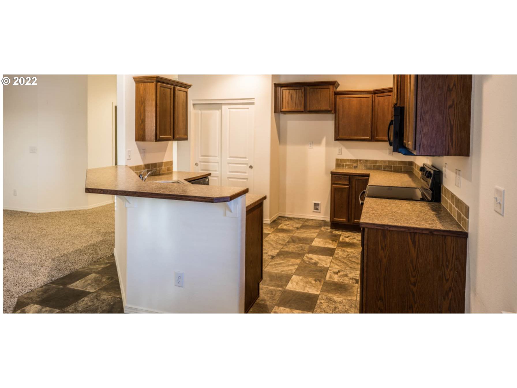 4902 Holly Street Springfield, OR 97478 - Photo 9 of 16 a kitchen with sink a microwave and refrigerator