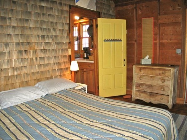 58 Forest Road West Tisbury, MA 02568 - Photo 12 of 29 a view of a bedroom with a bed and wooden floor