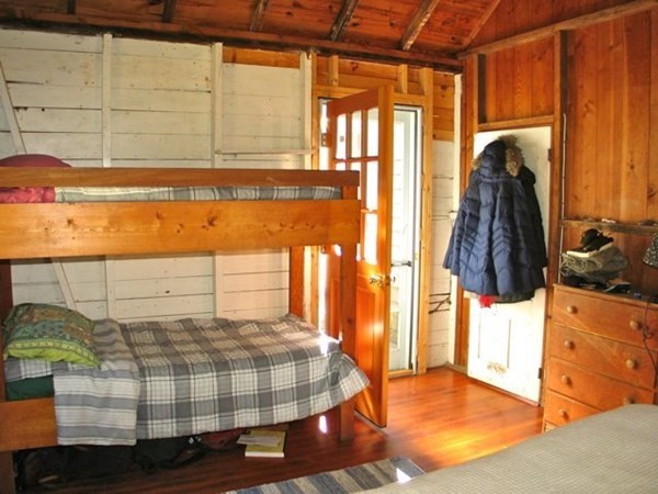 58 Forest Road West Tisbury, MA 02568 - Photo 14 of 29 a bedroom with a bed and painting on the wall