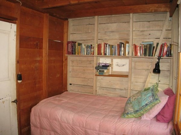 58 Forest Road West Tisbury, MA 02568 - Photo 16 of 29 a bedroom with a bed and a book shelf
