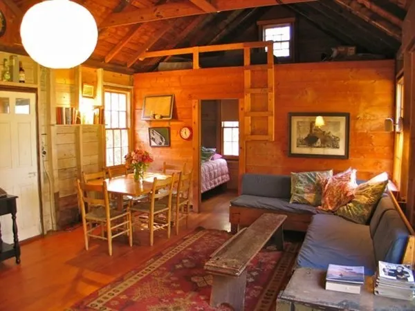 a living room with furniture a table and chairs