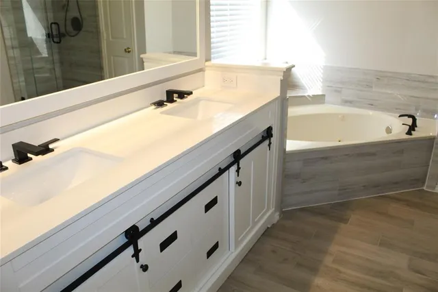 a bathroom with a bathtub and a sink