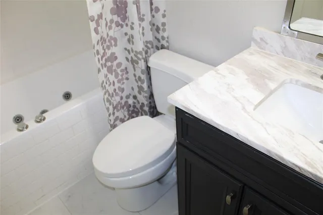 a bathroom with a toilet a sink and bathtub
