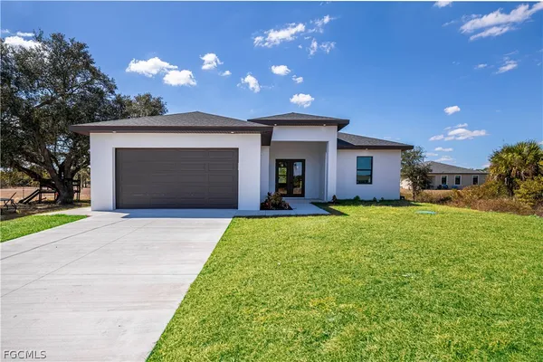 a front view of a house with a yard and garage