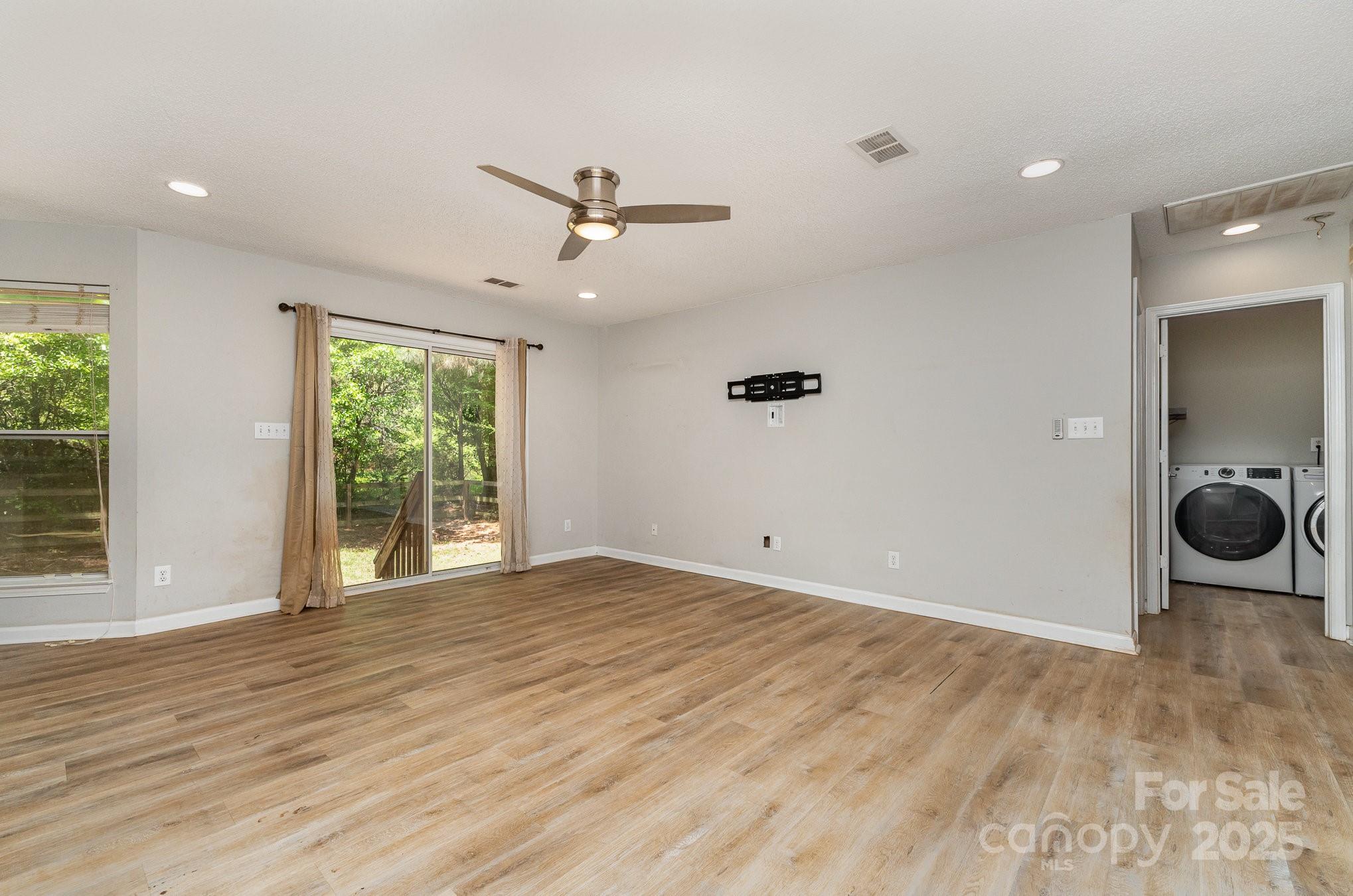 2014 Cardinal Loop Stanley, NC 28164 - Photo 12 of 40 wooden floor in an empty room with a window