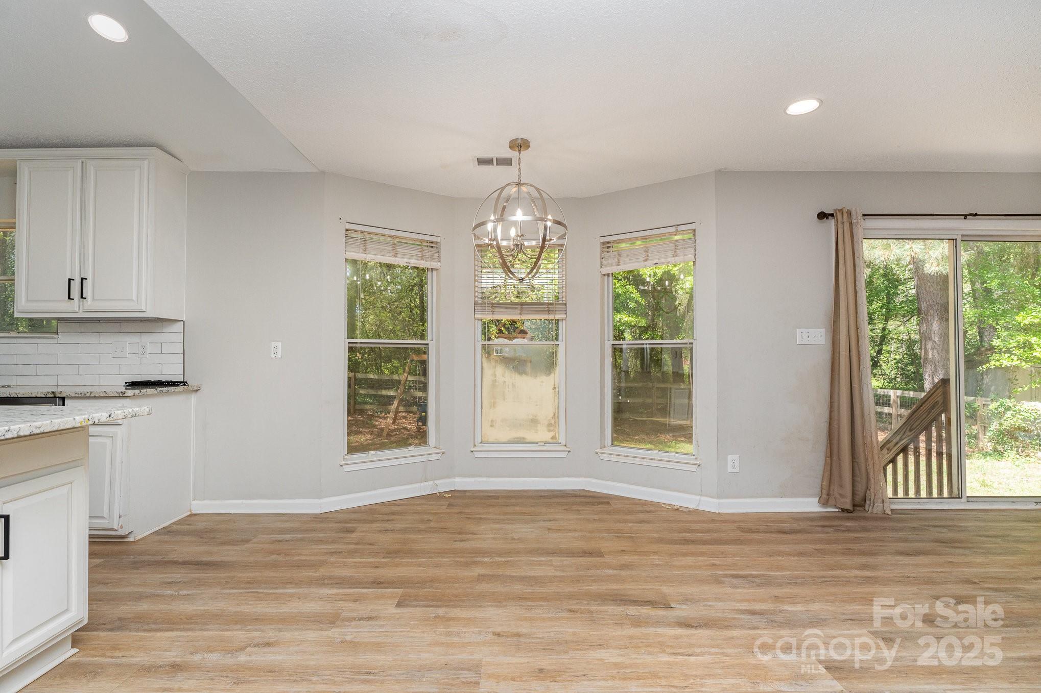 2014 Cardinal Loop Stanley, NC 28164 - Photo 14 of 40 a view of an empty room with wooden floor and a window
