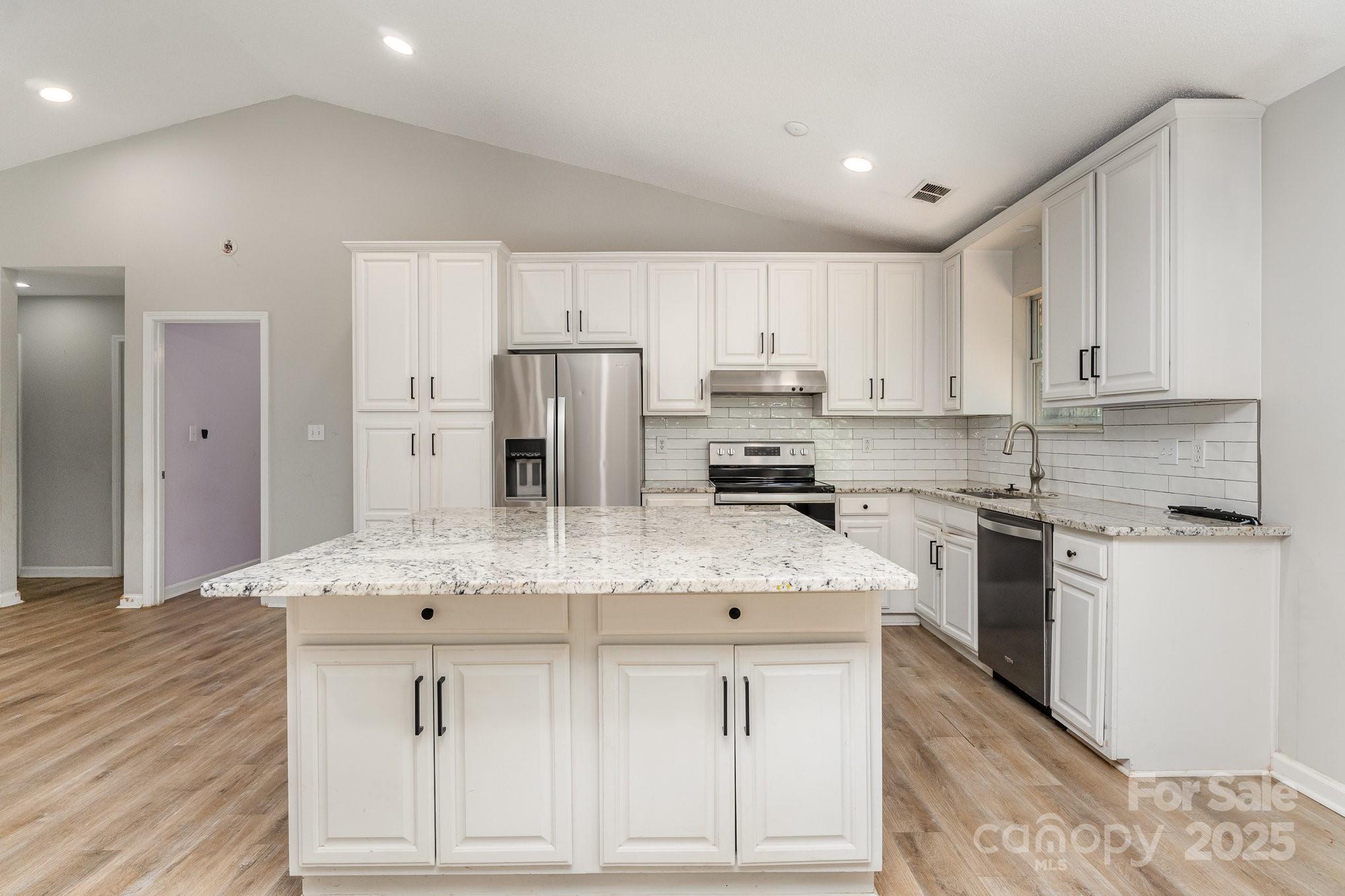 2014 Cardinal Loop Stanley, NC 28164 - Photo 16 of 40 a kitchen with stainless steel appliances granite countertop a stove a sink and a refrigerator