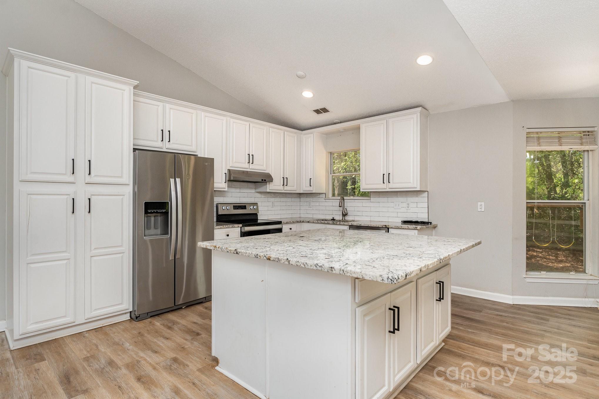 2014 Cardinal Loop Stanley, NC 28164 - Photo 17 of 40 a kitchen with stainless steel appliances granite countertop a sink stove and refrigerator