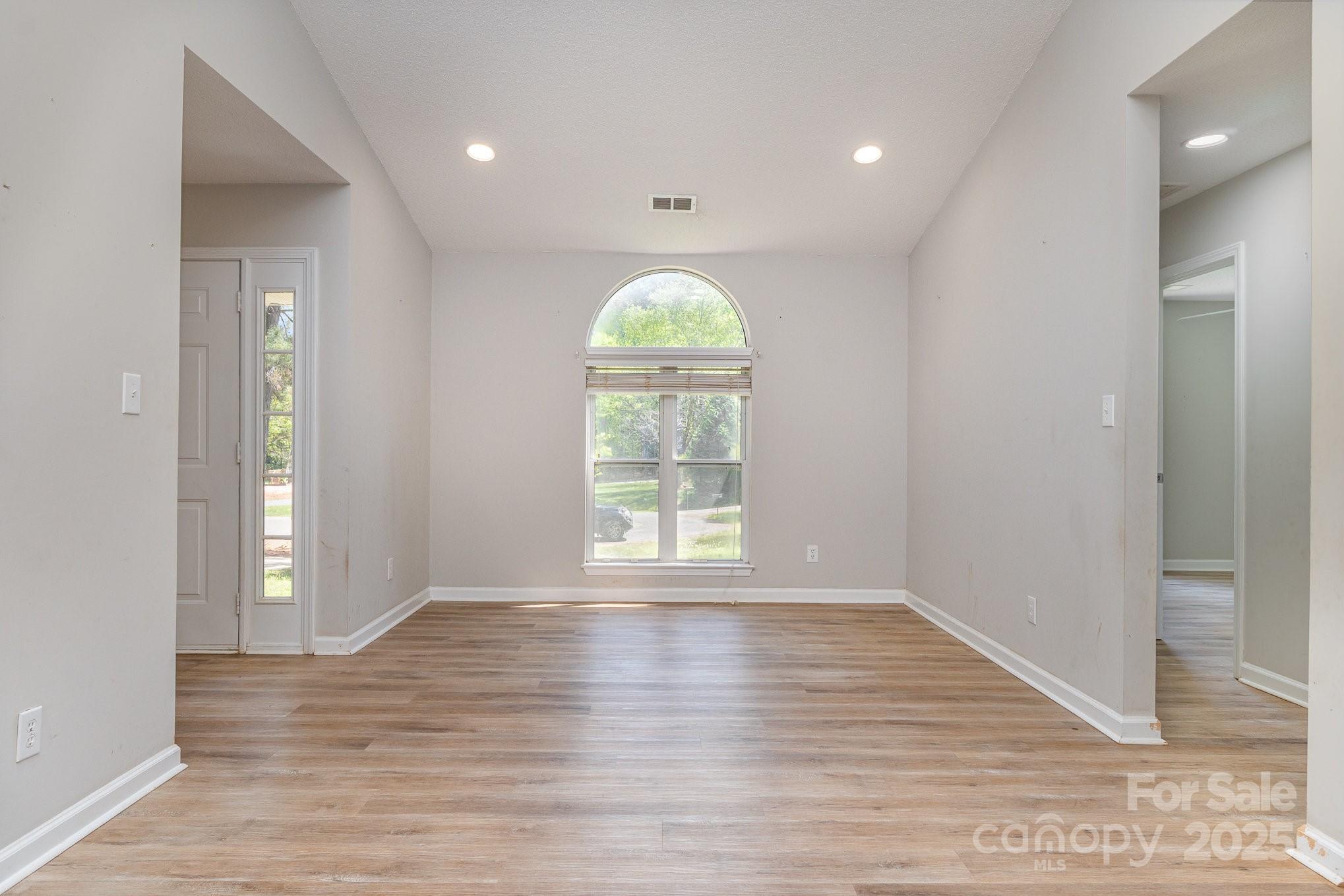 2014 Cardinal Loop Stanley, NC 28164 - Photo 21 of 40 a view of an empty room with wooden floor and a window