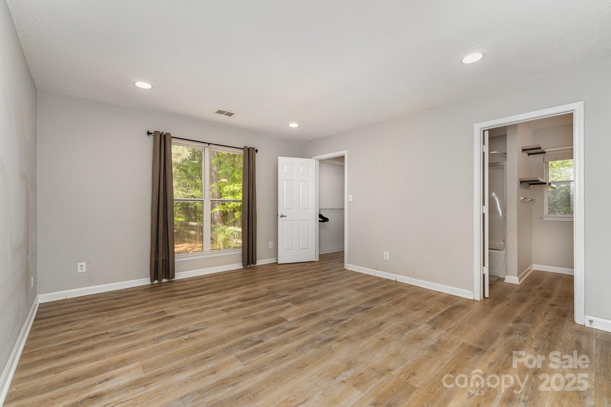 2014 Cardinal Loop Stanley, NC 28164 - Photo 23 of 40 a view of an empty room with wooden floor and a window