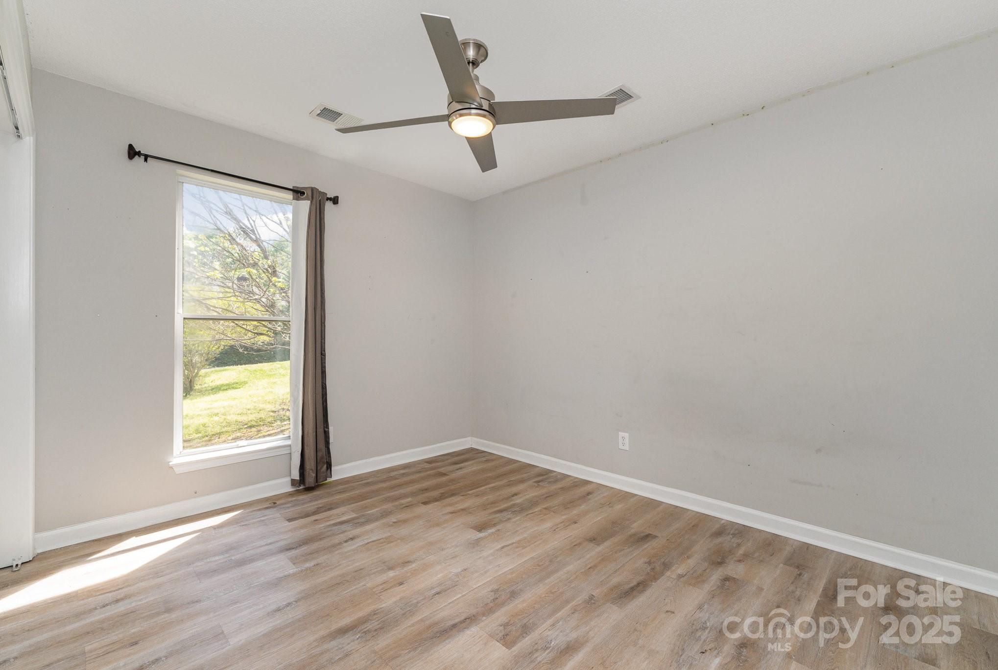 2014 Cardinal Loop Stanley, NC 28164 - Photo 26 of 40 wooden floor in an empty room with a window