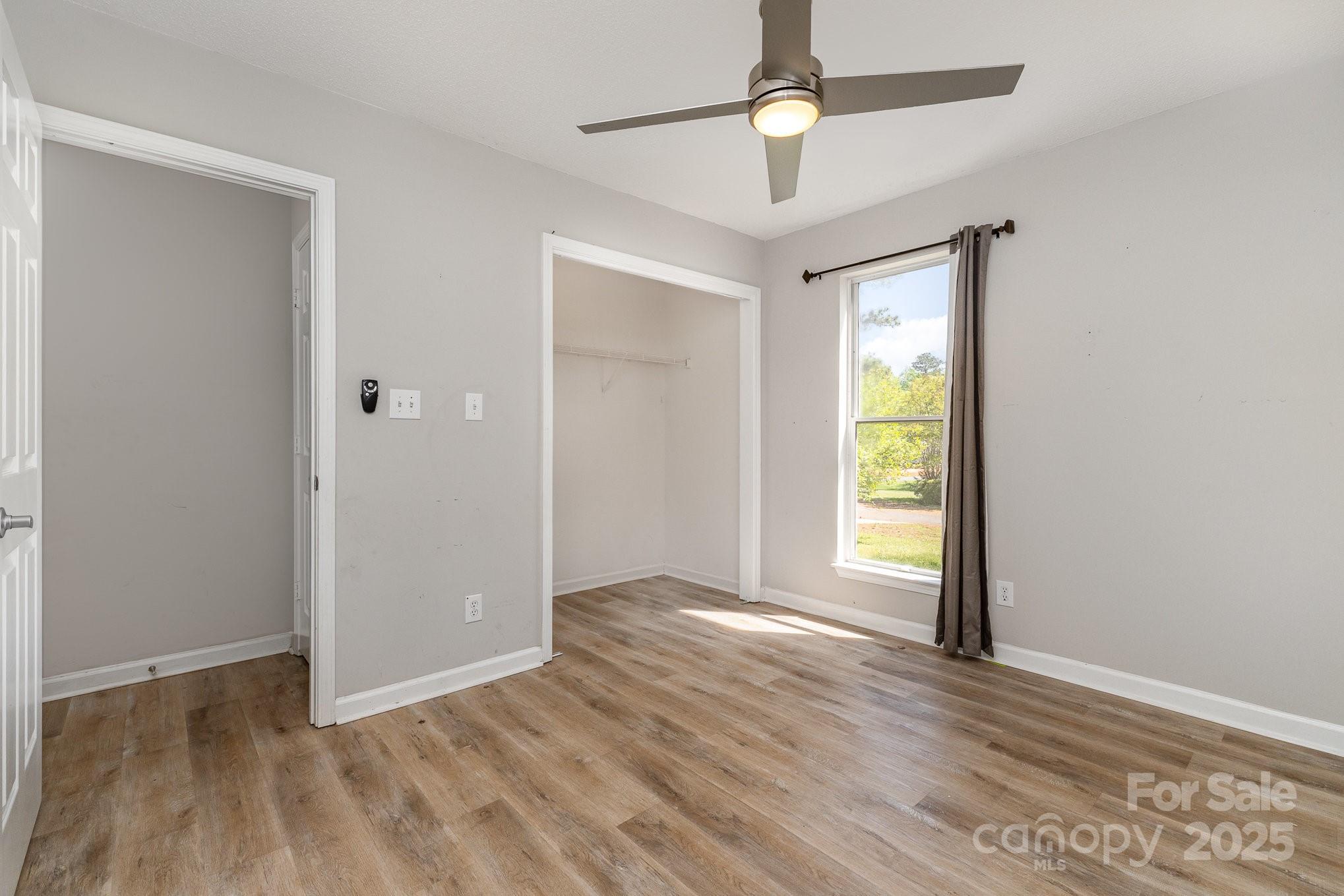 2014 Cardinal Loop Stanley, NC 28164 - Photo 27 of 40 an empty room with wooden floor fan and windows