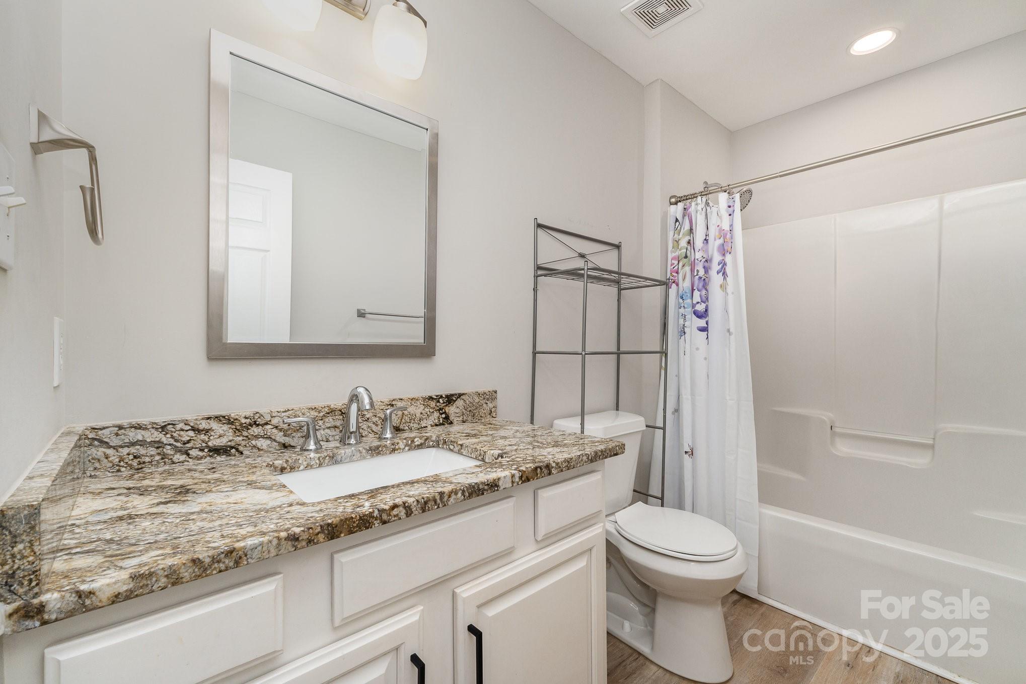 2014 Cardinal Loop Stanley, NC 28164 - Photo 30 of 40 a bathroom with a granite countertop sink toilet and shower