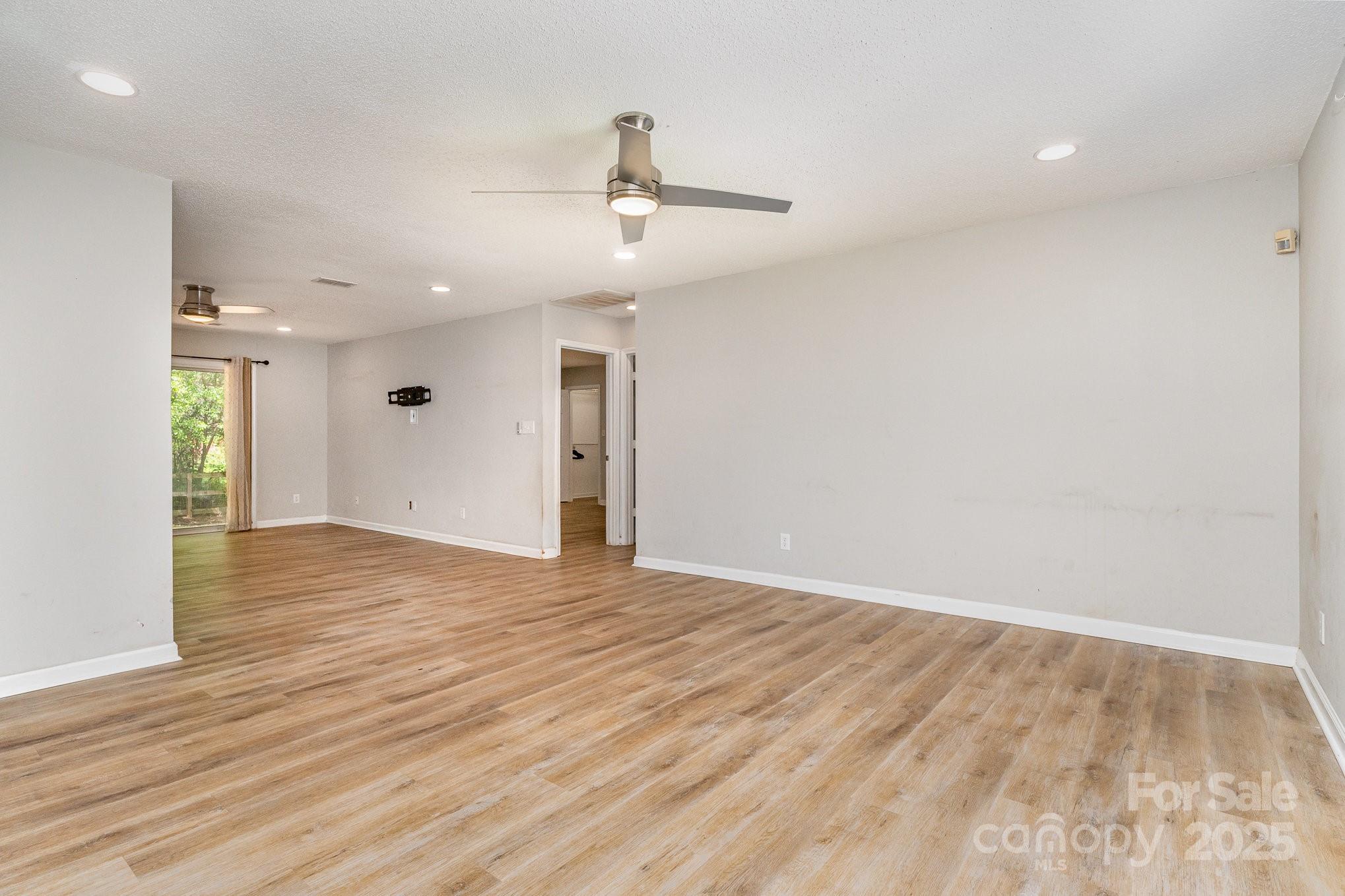 2014 Cardinal Loop Stanley, NC 28164 - Photo 7 of 40 an empty room with wooden floor and windows